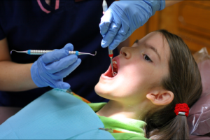 dentist checking the teeth of a child